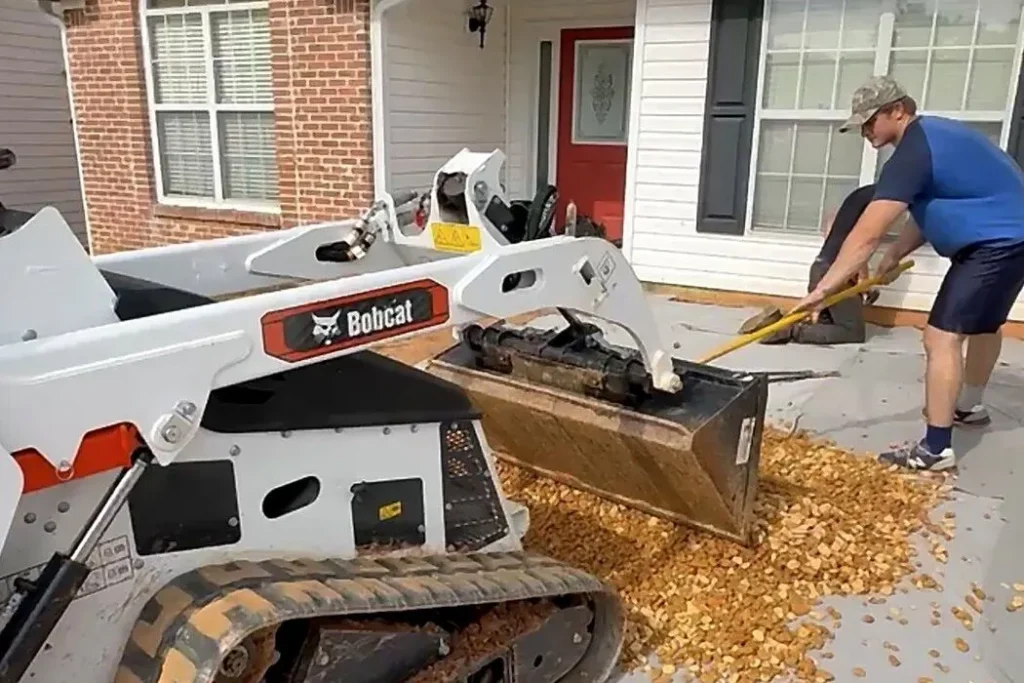 2MT Services spreading gravel base over filter fabric for a driveway extension in Kennesaw, Georgia